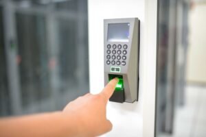 Fingerprint scanner unlocking a door — illustrating biometric smart lock access