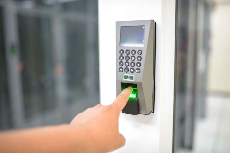 Fingerprint scanner unlocking a door — illustrating biometric smart lock access