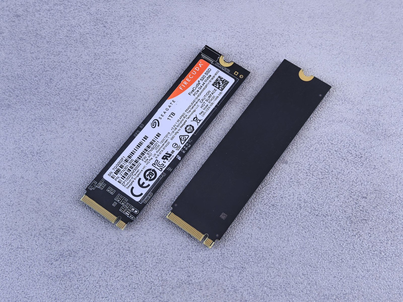 Two NVMe SSDs on a gray background — illustration for best budget NVMe SSD Proxmox picks